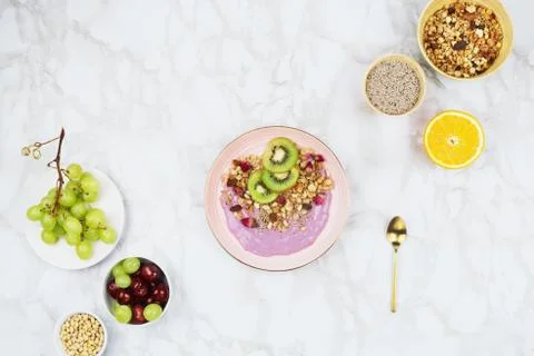 Flatlay of vegan breakfast with plant based yogurt topped with kiwi slices, g Stock Photos