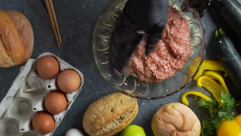 Flatlay video of chef pressing minced meat with spices in crystal bowl with.. Stock Footage 321313951