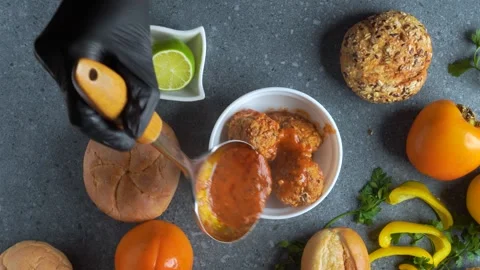 Flatlay video of chef serving meatballs with tomato sauce in white bowl wit.. Stock Footage 321347440