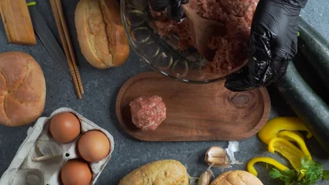 Flatlay video of forming meatballs and placing them on wooden plate with in.. Stock Footage 321348486