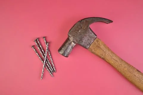 Flatlay View of Hammer and Nails Isolated on a Pink Background Stock Photos