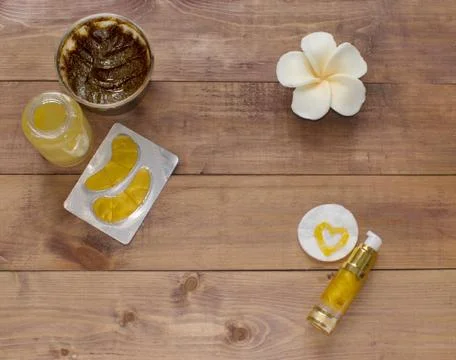 Flatlay view spa cosmetics products for face and body on wooden background Stock Photos