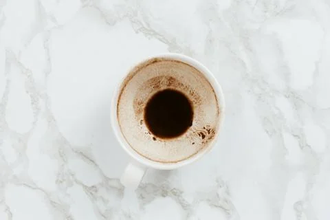 Flatlay of white cup of drunk cacao on marble background Stock Photos