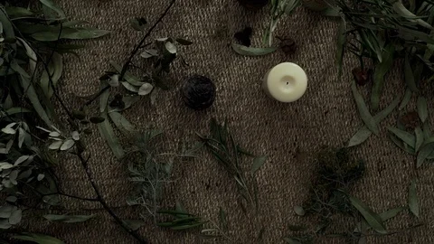 Flatlay with wicker mat, dry plants, and a candle. Close-up of female hands Stock Footage 124862138