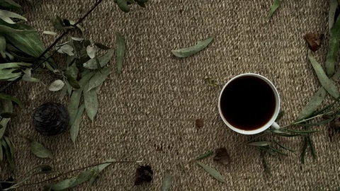 Flatlay with a wicker mat, dry plants, a notebook and a cup of coffee. Close-up Stock Footage 124862799