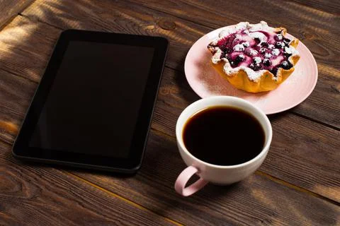 Flatley coffee break layout. Digital tablet gadget, black coffee in a cup and Stock Photos