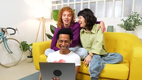 Flatmates using laptop sitting on the sofa Stock Footage 292223310