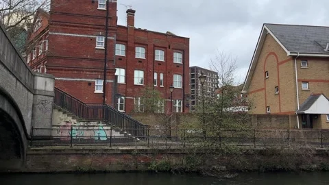 Flats in a converted building by the river in England 스톡 동영상 332117701