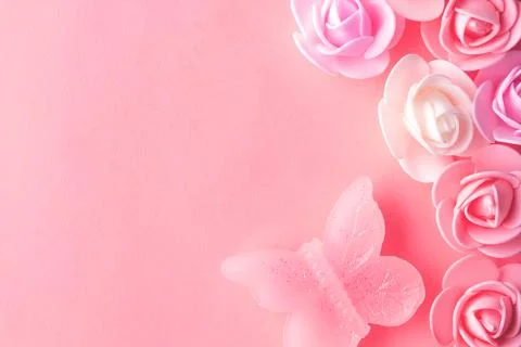 Flats on a pink background lined with small flowers and a butterfly Stock Photos