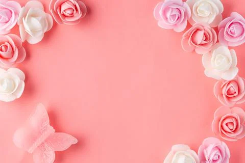 Flats on a pink background lined with small flowers and a butterfly Stock Photos