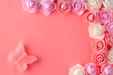 Flats on a pink background lined with small flowers and a butterfly Stock Photos