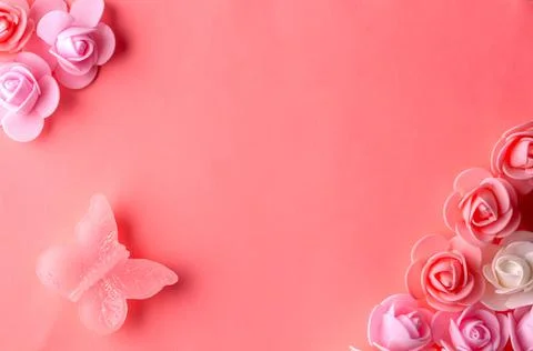 Flats on a pink background lined with small flowers and a butterfly Stock Photos