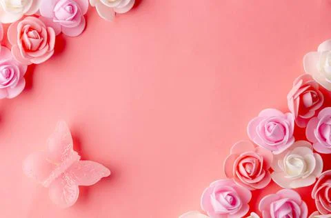 Flats on a pink background lined with small flowers and a butterfly Stock Photos