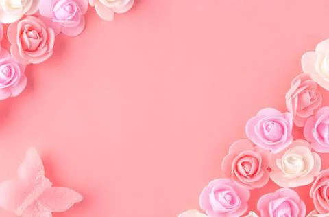 Flats on a pink background lined with small flowers and a butterfly Stock Photos