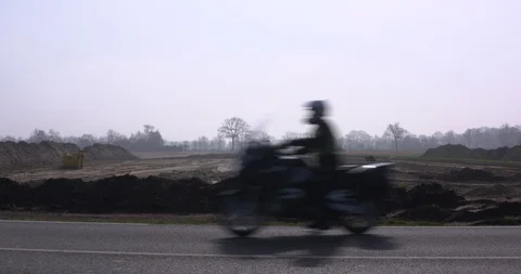 Flattened and leveled construction site for a bypass roadway + traffic passes by Stock Footage 107203125