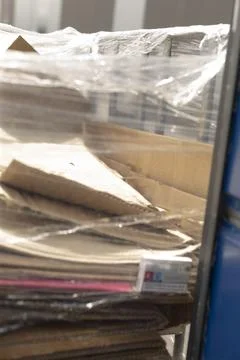 Flattened boxes staged outside loading bay for curbside recycling pickup 스톡 사진