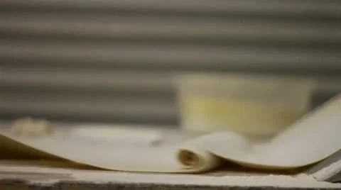 Flattening dough with machine pan right Stock Footage 9454401