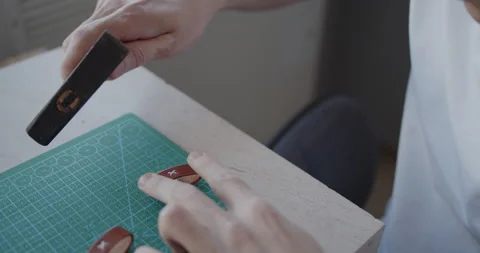 Flattening threads on a leather loop used with a belt with a hummer close-up Stock Footage 146137952