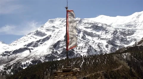 Flattering flag in front of snowy mountain Stock Footage 67647035
