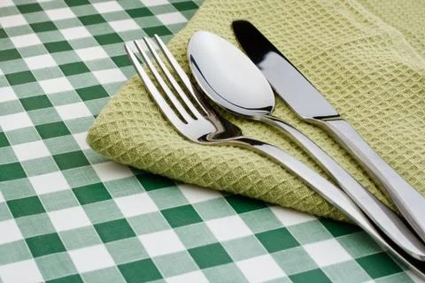 Flatware on green gingham table cloth Foto stock