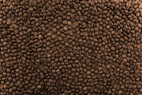 Flavored Coffee Beans Background. Invigorating coffee energy- image. Stock Photos