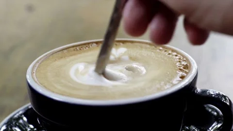 Flavored coffee in a mug on wooden table at coffee shop. Stock Footage 334648900