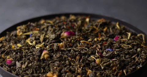 Flavored green tea leaves rotating in seamless tilt shift loop Video stock 320979218