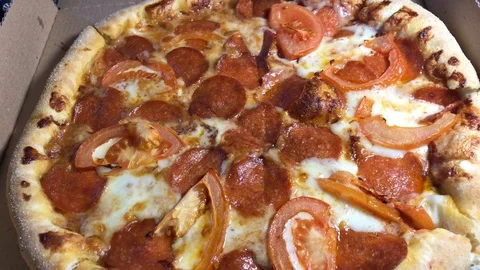 Flavored pizza in a paper box Stock Footage 106575285