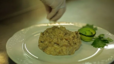 Flavoring risotto with parsley Stock Footage 88439547