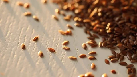 Flax seeds fall on the table Stock Footage 167574039