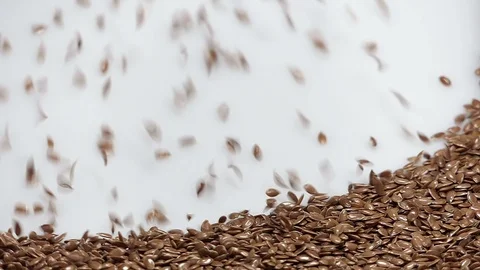 Flax seeds on white background falling from top and filling up frame Stock Footage 112270903
