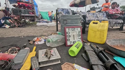 Flea Market Stall Ground Display Featuring Vintage Square Clock and Plastic Stock Footage 346083630