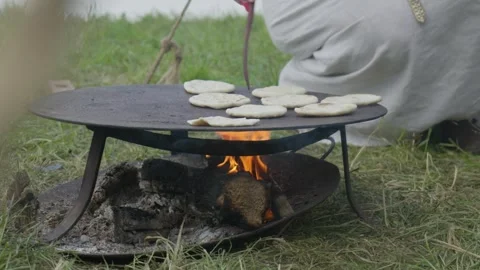 Fleatbread coocking in a medieval camp Stock Footage 302028259