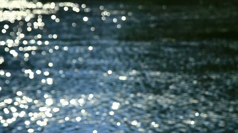 Flecks of sunlight sparkle in fast moving water current. 스톡 동영상 53428181