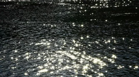 Flecks of sunlight sparkle in fast moving water current. 스톡 동영상 53430297