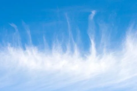 Fleecy clouds against a background blue sky Stock Photos