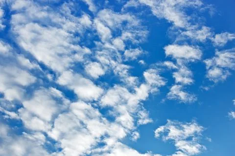 Fleecy clouds on blue sky background Stock Photos