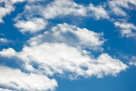 Fleecy clouds on blue sky background Stock Photos