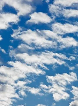 Fleecy clouds on blue sky background Stock Photos