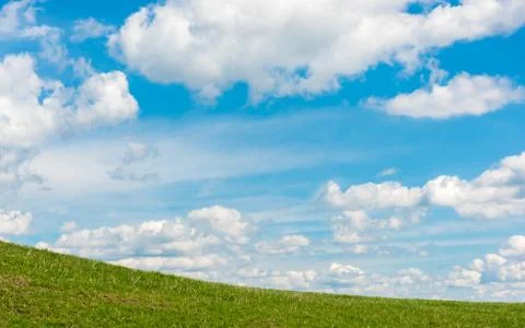 Fleecy clouds on a spring day Stock Photos