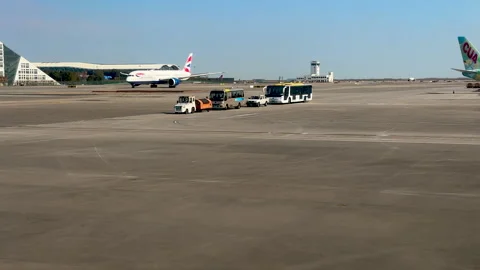 Fleet of apron passenger bus, van and guiding cars waiting on tarmac Stock Footage 297739695
