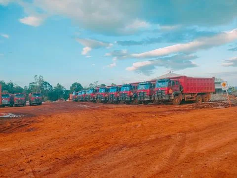 Fleet of Heavy Duty Dump Trucks Parked at an Industrial Mining Site Stock Photos