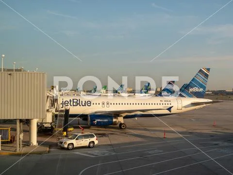 Fleet of JetBlue airliners waiting for refuel at JFK Airport Stock Photos