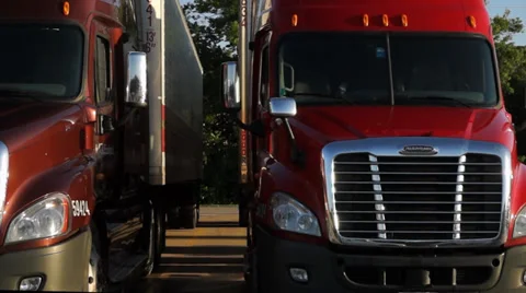 Fleet of Semi trucks in parking lot Stock Footage