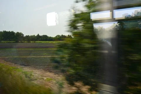 Flemish landscape seen from inside a train in motion Stock Photos