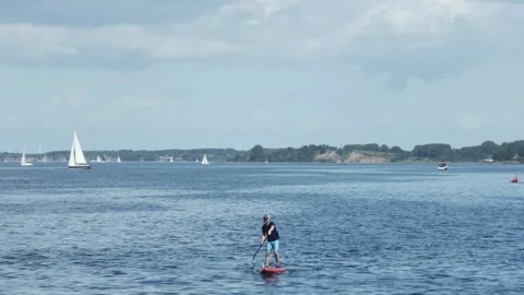 Flensburg, Germany - August 20, 2023. an athlete rows while standing on a fl Vídeos de archivo 260830221