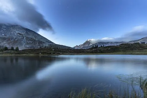 Fletschhorn mountain peak reflected in the pristine water of Hopschusee lake at Stock Photos