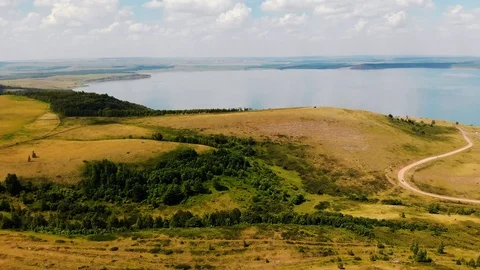 Flew over the summer fields and a large lake on a sunny day. Stock Footage 106179380