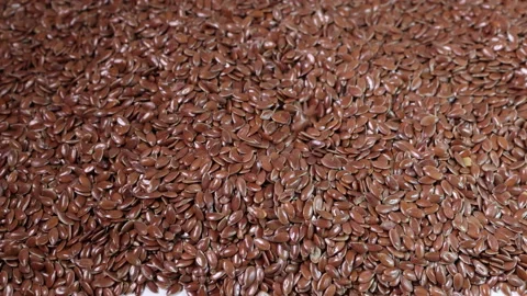 Flex seed flaxseed drop pour on pile  Stock Footage 157899523