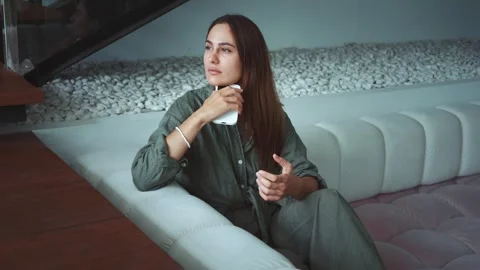 Flexibility of remote freelancing woman uses phone for remote work while sitting Stock Footage 312509746